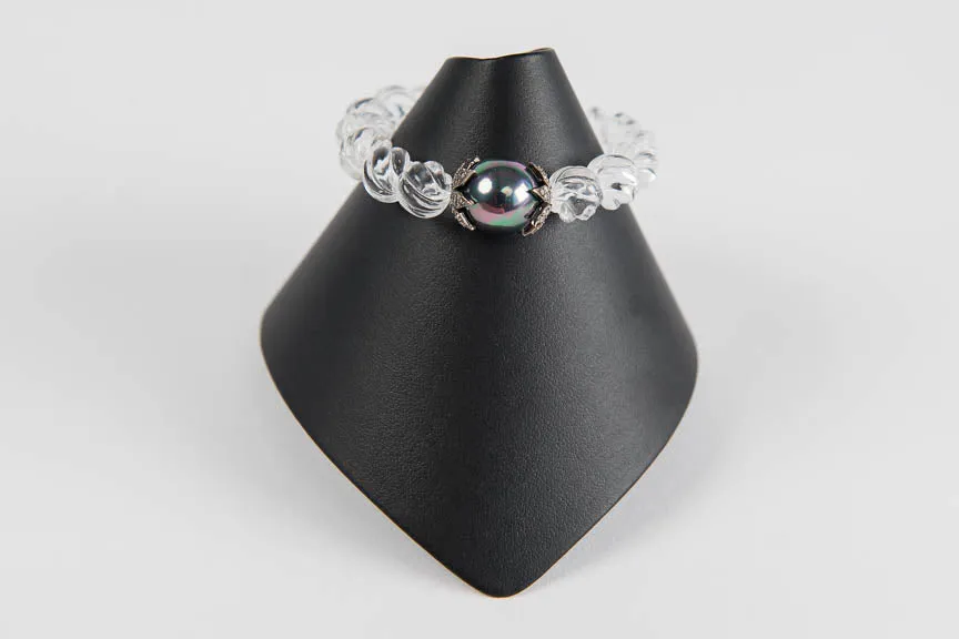 Carved rock crystal with mother of pearl and pave diamond bead caps